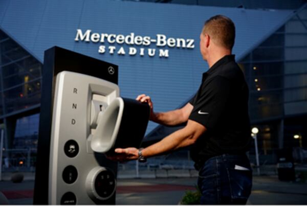 Mercedes-Benz Stadium lit up on Thursday morning as MBUSA vice president of marketing Drew Slaven flipped the switch to light up the three-pointed star and script in Atlanta. (Jason Hales/Mercedes-Benz)