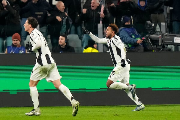 Juventus' Weston McKennie, right, celebrates his side's second goal during the Champions League, opening phase soccer match between Juventus and Manchester City at the Allianz stadium in Turin, Italy, Tuesday, Wednesday, Dec.11, 2024. (AP Photo/Luca Bruno)