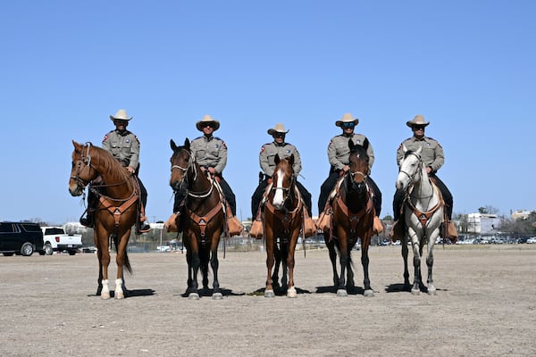 Member of the U.S. Border Patrol watch on horseback as Vice President JD Vance speaks to reporters during a visit to the U.S. border with Mexico Wednesday, March 5, 2025 in Eagle Pass, Texas. (Brandon Bell/Pool via AP)