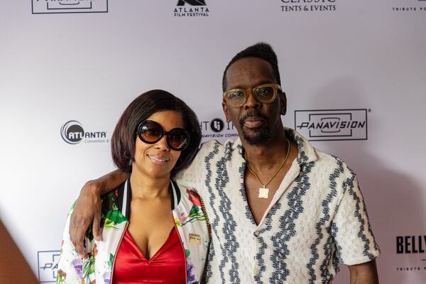 Painter Fahamu Pecou, right, arrives on the red carpet for the screening of “The South Got Something to Say” at the Atlanta Film Festival on Wednesday, May 1, 2024. Pecou is featured in the documentary. (Kymani Culmer for The Atlanta Journal-Constitution)