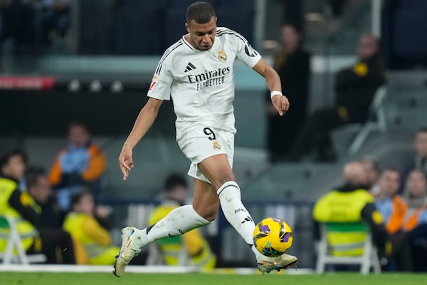 Real Madrid's Kylian Mbappe takes control of the ball during the Spanish La Liga soccer match between Real Madrid and Getafe at the Santiago Bernabeu Stadium in Madrid, Spain, Sunday, Dec. 1, 2024. (AP Photo/Bernat Armangue)