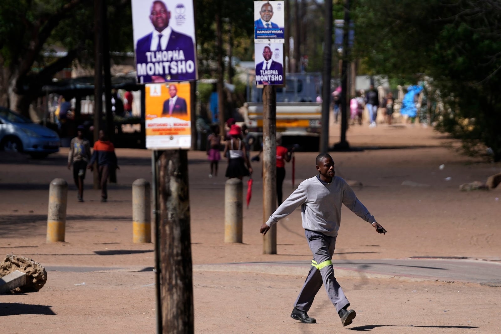 A man walks passes election posters, a day before elections in Gaborone, Botswana, Tuesday, Oct. 29, 2024. (AP Photo/Themba Hadebe)