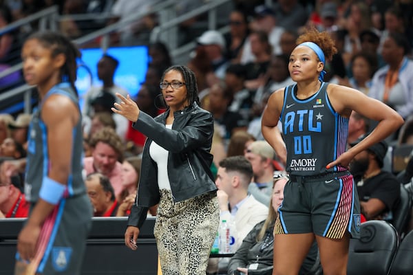 Atlanta Dream head coach Tanisha Wright, center, and Atlanta Dream forward Naz Hillmon (00) talk on the sideline during their game against the Indiana Fever at State Farm Arena, Friday, June 21, 2024, in Atlanta. Indiana won 91-79. (Jason Getz / AJC)
