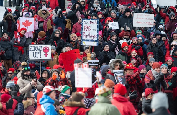 Protestors take part in a "Mothers out Front" demonstration against U.S. President Donald Trump and Elon Musk near the United States embassy in Ottawa, Saturday, March 8, 2025. (Spencer Colby/The Canadian Press via AP)