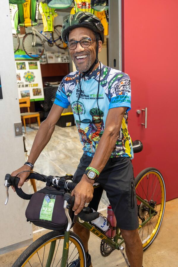 Atiba Mbiwan, the director of the BRAG Dream Team, poses on his bicycle inside the organization's headquarters at Pittsburgh Yards in Atlanta. (Phil Skinner for the AJC)