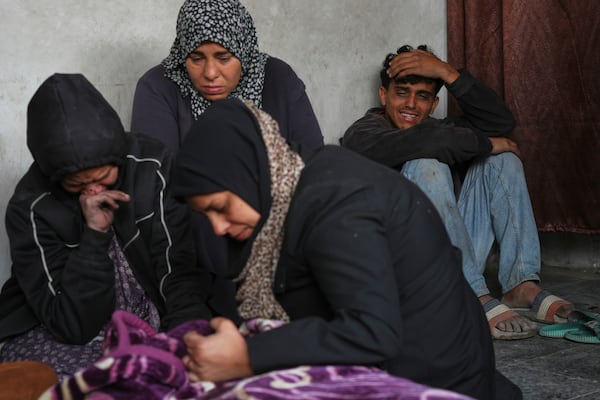 Members of the Abu Aker family mourn over the bodies of their relatives killed during an Israeli army strike before their burial at the Baptist hospital in Gaza City, Monday, March 24, 2025.(AP Photo/Jehad Alshrafi)