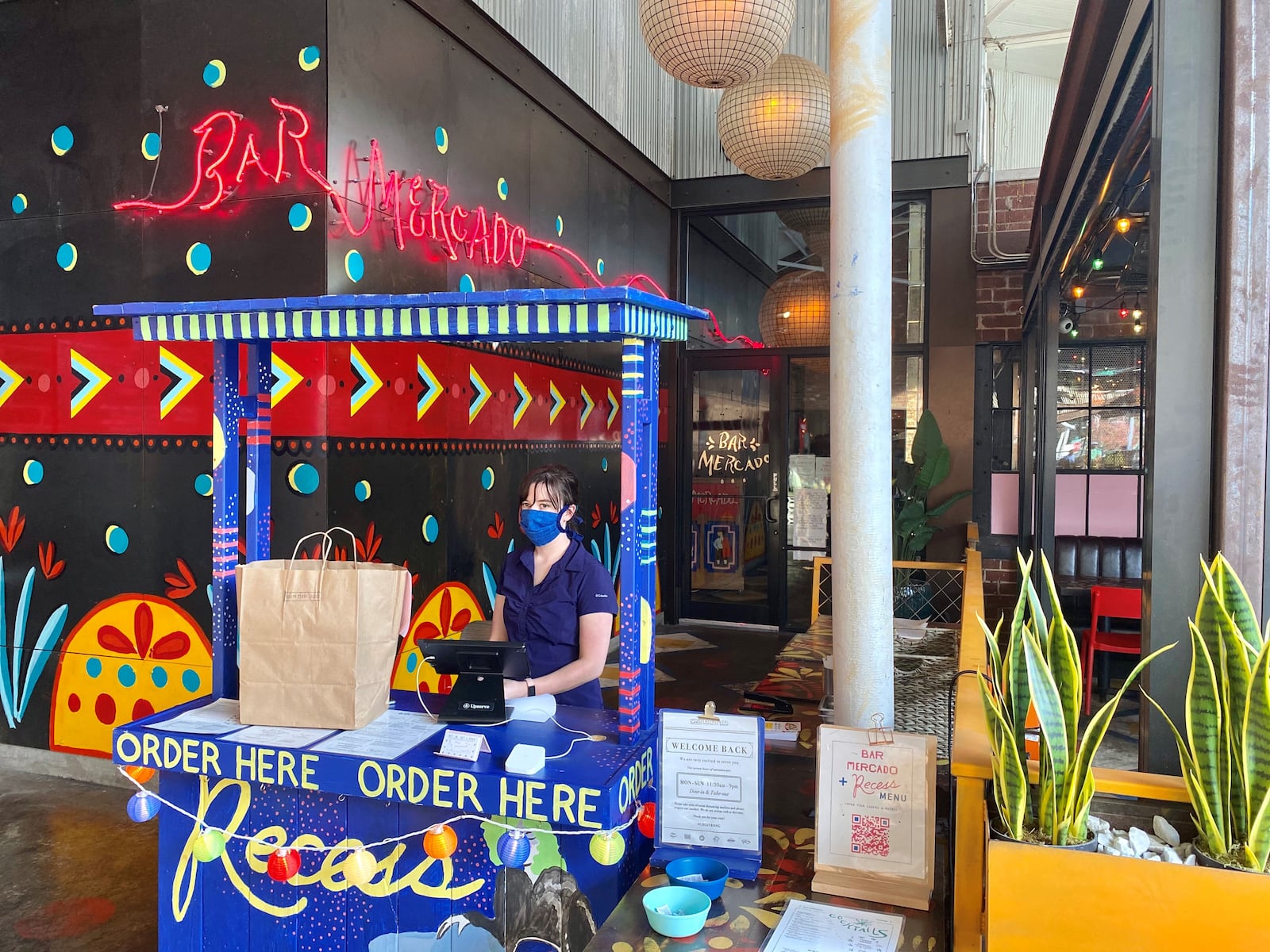 Bar Mercado at Krog Street Market has a festive stand for ordering and picking up takeout, which it shares with sister restaurant Recess. Wendell Brock for The Atlanta Journal-Constitution