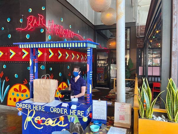 Bar Mercado at Krog Street Market has a festive stand for ordering and picking up takeout, which it shares with sister restaurant Recess. Wendell Brock for The Atlanta Journal-Constitution