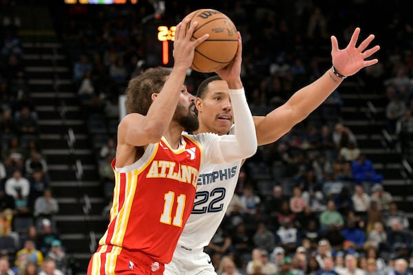 Atlanta Hawks guard Trae Young (11) handles the ball against Memphis Grizzlies guard Desmond Bane (22) in the first half of an NBA basketball game Monday, March 3, 2025, in Memphis, Tenn. (AP Photo/Brandon Dill)