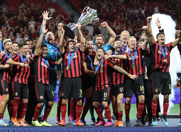 August 27, 2019 Atlanta: Atlanta United players hoist the Lamar Hunt Trophy after defeating Minnesota United 2-1 to win the U.S. Open Cup on Tuesday, August 27, 2019, in Atlanta.  Curtis Compton/ccompton@ajc.com