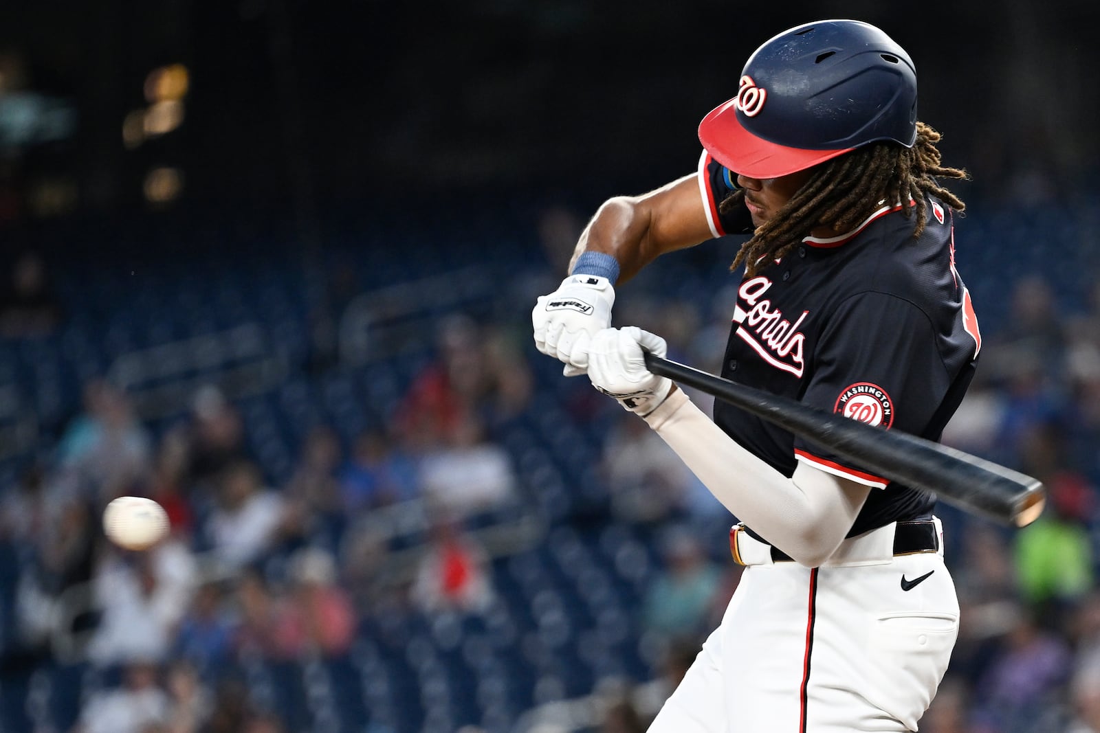 Washington Nationals' James Wood hits an infield single to drive in a run during the third inning of a baseball game against the Atlanta Braves, Wednesday, Sept. 11, 2024, in Washington. (AP Photo/John McDonnell)