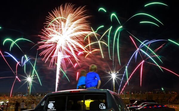 Two boys sit on the roof of their family's truck as they watch the Clark County Fourth of July Fireworks Monday at the Clark County Fairgrounds. BILL LACKEY/STAFF