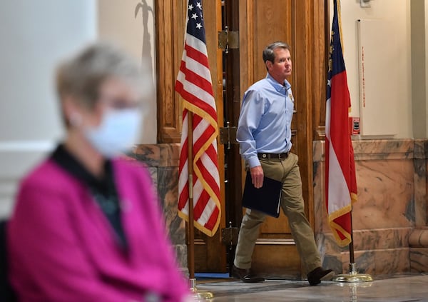 Gov. Brian Kemp walks to the podium before he speaks during a press briefing to update on COVID-19 at the Georgia State Capitol on Tuesday, May 12, 2020. HYOSUB SHIN / HYOSUB.SHIN@AJC.COM