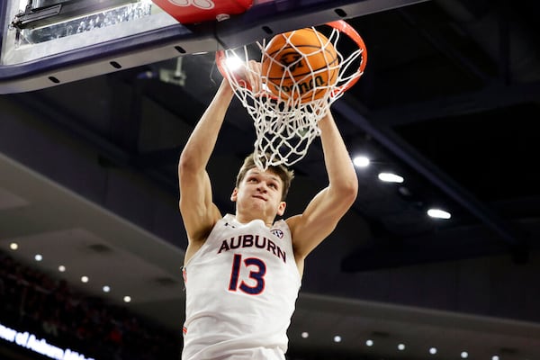 Auburn forward Walker Kessler (13) dunks against Georgia during the second half of an NCAA college basketball game Wednesday, Jan. 19, 2022, in Auburn, Ala. (AP Photo/Butch Dill)