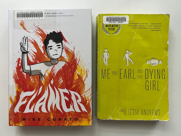 Two books - "Flamer" by Mike Curato and "Me and Earl and the Dying Girl" by Jesse Andrews - were removed from school libraries in Cobb County. The books in this photo were checked out from the Atlanta-Fulton Public Library.