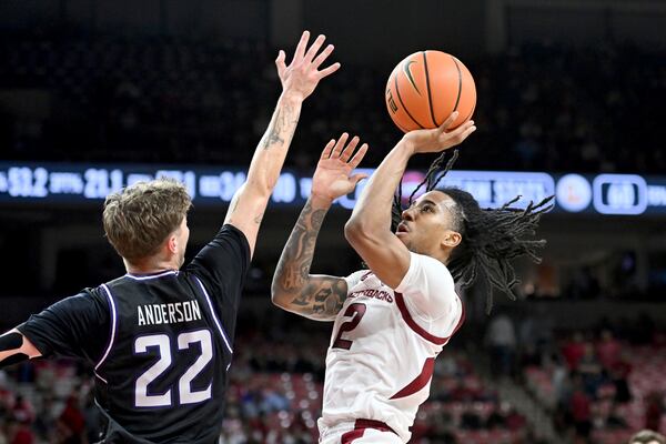 Arkansas guard Boogie Fland (2) shoots over Lipscomb guard Joe Anderson (22) during the second half of an NCAA college basketball game Wednesday, Nov. 6, 2024, in Fayetteville, Ark. (AP Photo/Michael Woods)