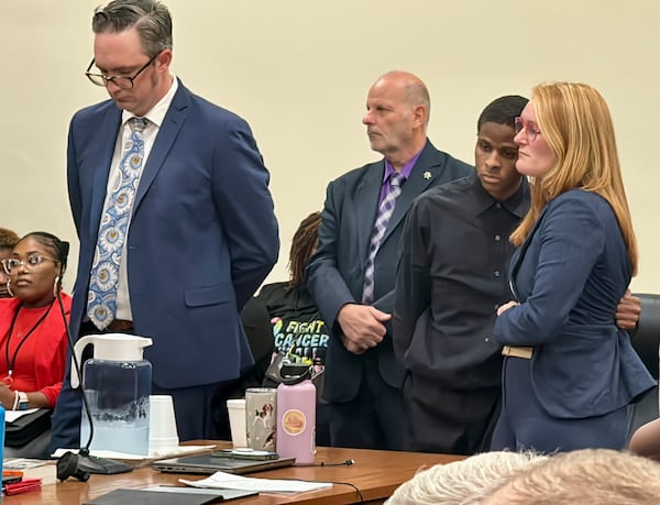 Jordan Lavoris Dean, second from right, hugged defense attorney MacKenzie Miller while the verdict was read Friday at his murder trial. (Joe Kovac Jr. / AJC)