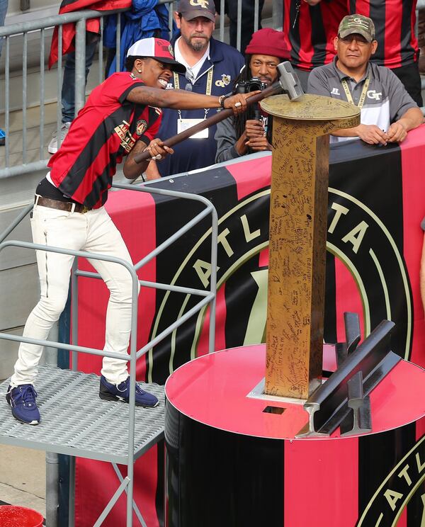 Rapper Rich Homie Quan hammers the ceremonial golden spike to open the Atlanta United game against the Chicago Fire on March 18, 2017, in Atlanta. Curtis Compton/ccompton@ajc.com