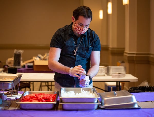 Addison Veitch makes gyros for the Atlanta Greek Festival in 2020, named  "A Road Trip to Greece" because last year's event, like this year's, was drive-thru service for food due to the coronavirus pandemic. The weekend event is held at the Greek Orthodox Cathedral of the Annunciation. STEVE SCHAEFER / SPECIAL TO THE AJC