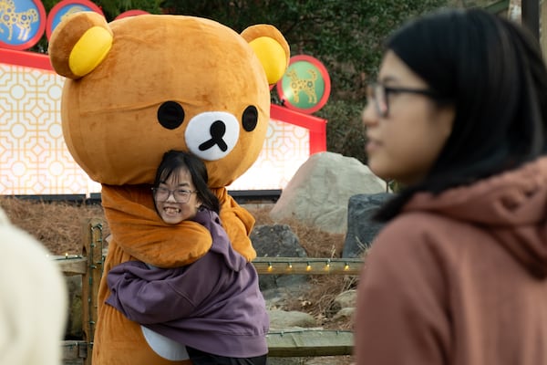 Grace Phan of Snellville gets a hug from the Japanese character Rilakkuma while attending the Lunar New Year Festival at Stone Mountain Park on Saturday, Jan. 25, 2025.   Ben Gray for the AJC