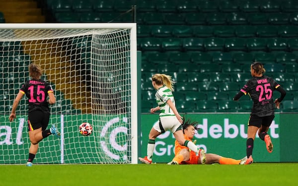 Celtic's Murphy Agnew, center, scores her side's first goal of the game, during the Women's Champions League, group B soccer match between Celtic Women and Chelsea Women, at Celtic Park, Glasgow, Scotland, Wednesday Nov. 13, 2024. (Andrew Milligan/PA via AP)