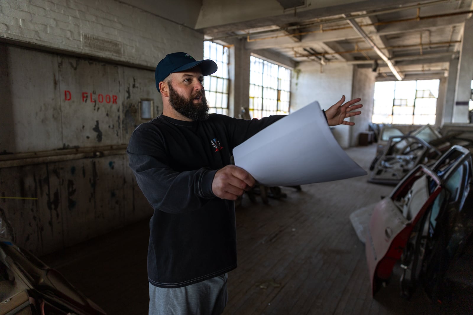 Andrew Braden, a principal at Braden Fellman, gives a tour of the building that used to be Johnson-Fluker Wholesale Candy Manufacturing Company’s factory in Atlanta on Wednesday, October 16, 2024. The building, which is now part of a scrap yard, is part of the Abrams Fixtures adaptive reuse project. (Arvin Temkar / AJC)