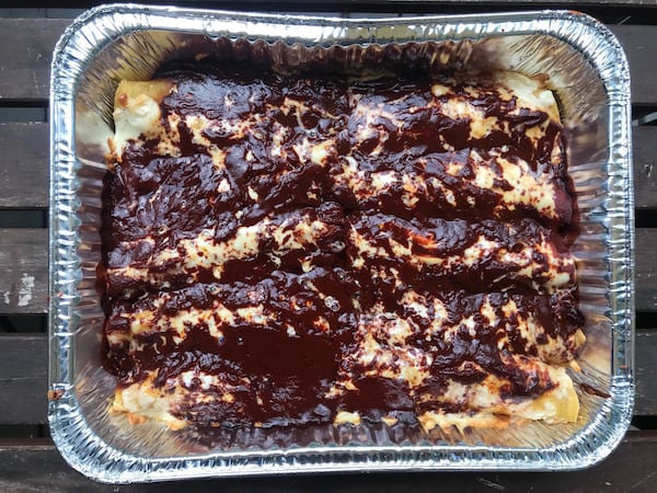 ñEl Ponce offers regular lunch and dinner menu items, as well as Quarantine Provisions that feature oven-ready single-portion and family-size meals, like enchiladas (pictured), which come with an order of beans and rice. LIGAYA FIGUERAS / LIGAYA.FIGUERAS@AJC.COM