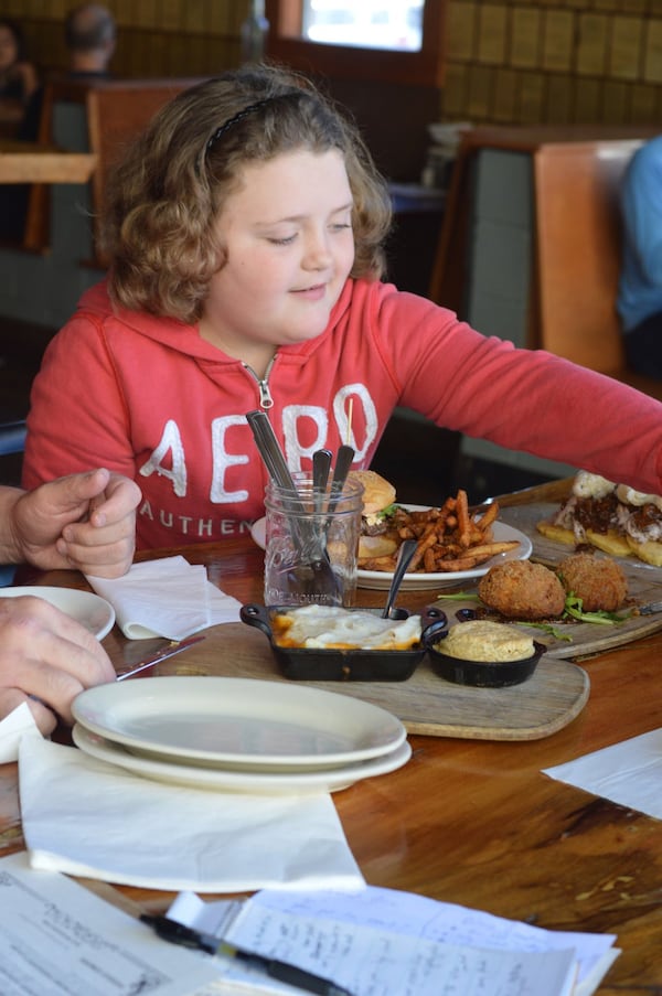 Aspiring chef Olivia Speaks samples several different dishes at Twain’s Brewpub & Billiards in Decatur. (photo: HENRI HOLLIS)