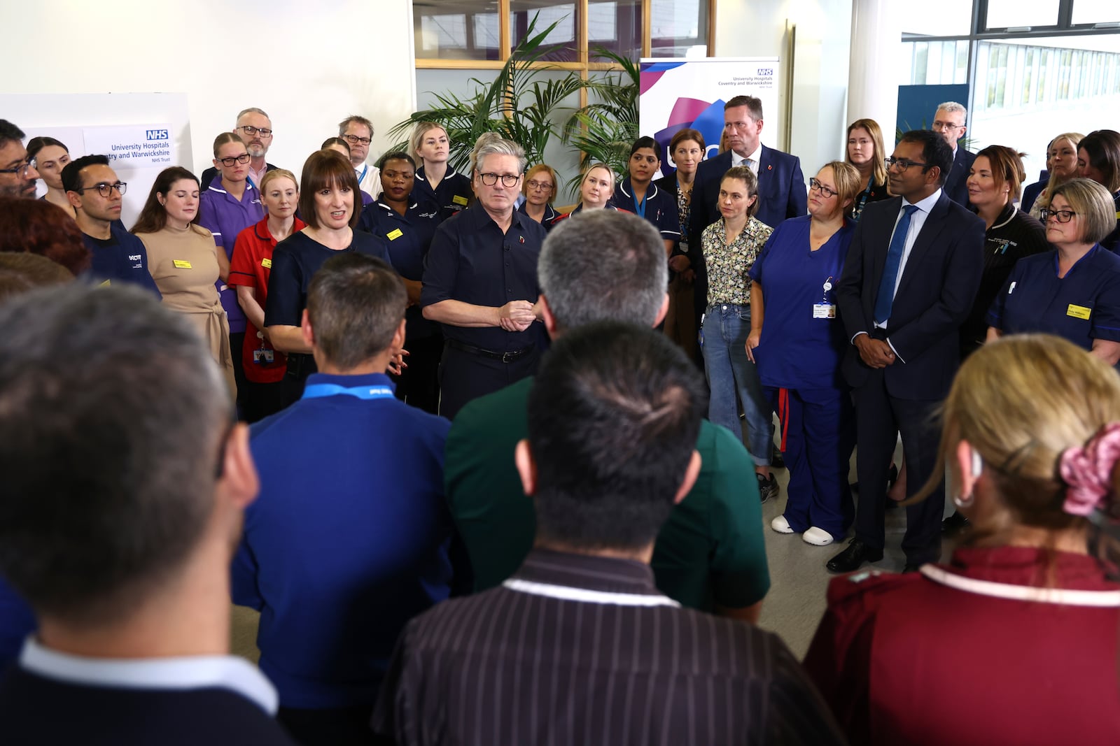 Britain's Prime Minister Keir Starmer and Chancellor Rachel Reeves speak with members of staff, during a visit to University Hospital Coventry and Warwickshire, in Coventry, England, Thursday, Oct. 31, 2024. (AP Photo/Darren Staples, pool)