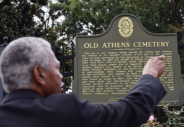 Fred Smith stands at a state historical marker on campus near the entrance to the Old Athens Cemetery near Baldwin Hall.