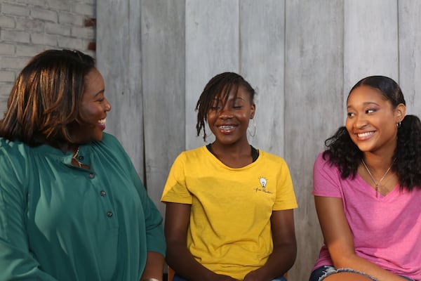 Latasha Morrison talks with student members of Be the Bridge, the faith-based organization she founded to promote racial unity. Contributed