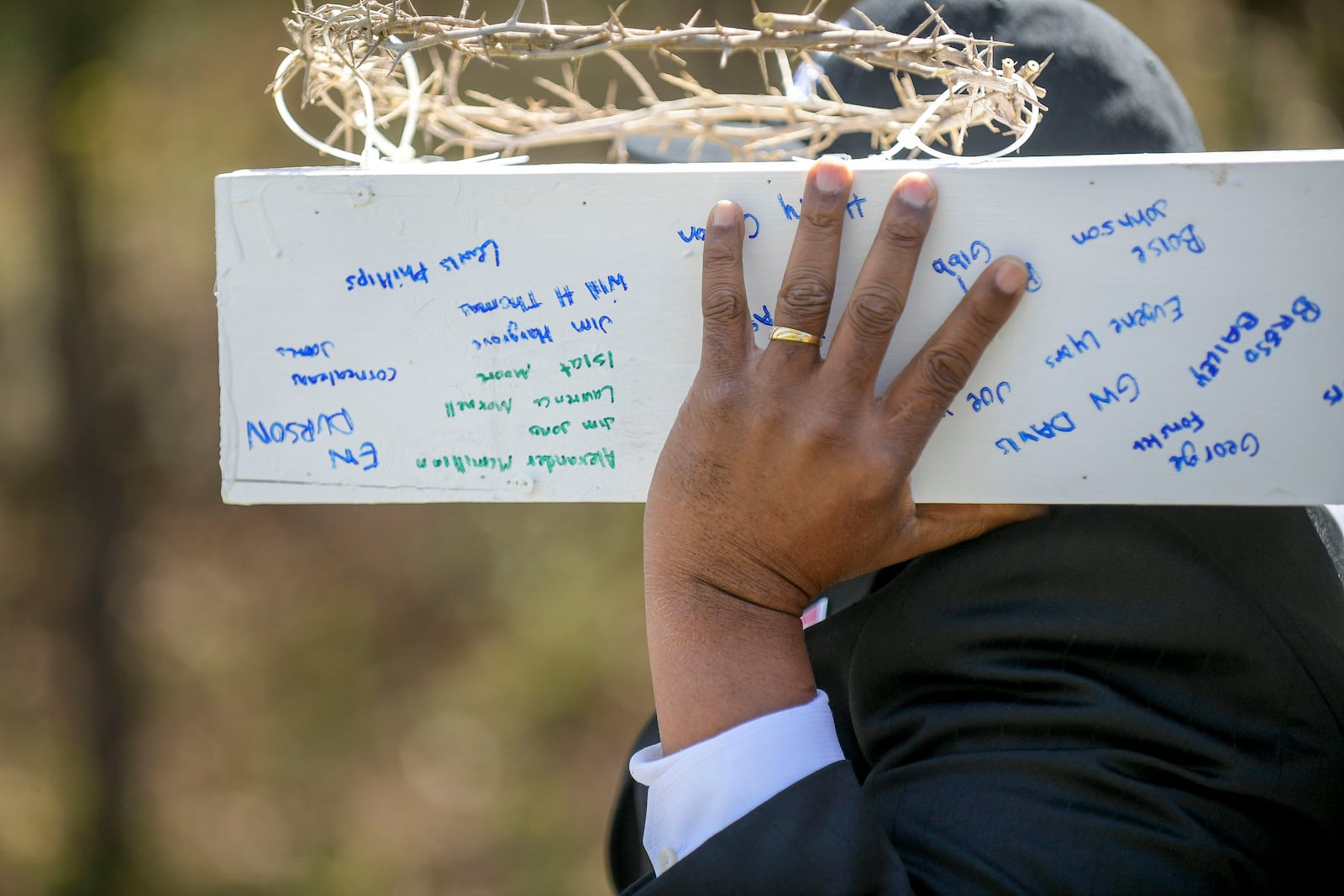 Names of the victims of the Chattahoochee Brick Company are seen on a cross carried by participants of a sacred event to commemorate the lives lost during a period the company used the convict lease system. The event included a procession, prayers, libations, community testimonials and site consecration Saturday, April 3, 2021, in Atlanta. (Photo: Daniel Varnado for The Atlanta Journal-Constitution)