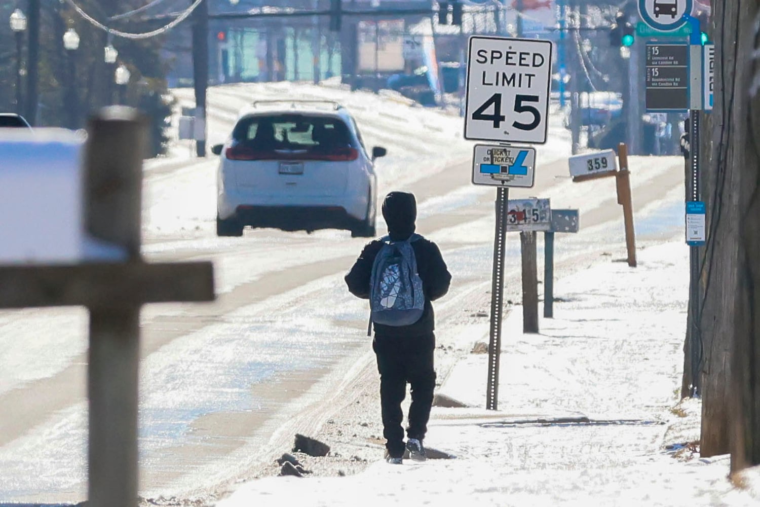 A pedestrian walks on an icy sidewalk on Candler Rd in Dekalb County on Wednesday, January 22, 2025, a day after a winter storm hit Metro Atlanta. Authorities advised people to stay home due to the icy road conditions.
(Miguel Martinez/ AJC)