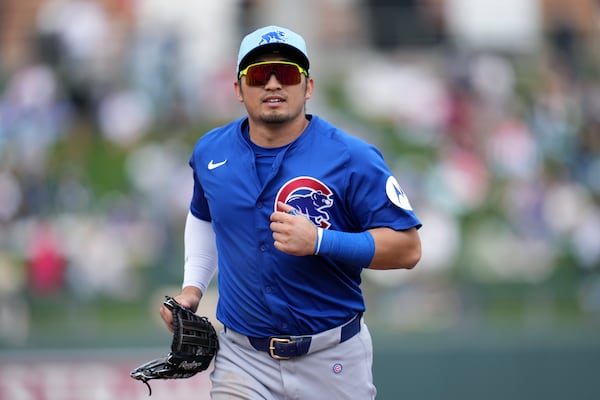 Chicago Cubs left fielder Seiya Suzuki, of Japan, jogs off the field during the third inning of a spring training baseball game against the Arizona Diamondbacks, Monday, March 3, 2025, in Scottsdale, Ariz. (AP Photo/Ross D. Franklin)