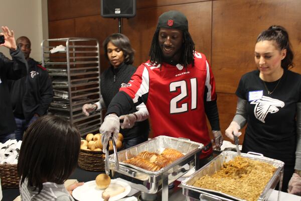 Cornerback Desmond Trufant serving a catered Thanksgiving meal to 124 men from the Shepherd’s Inn, the men’s facility of the Atlanta Mission on Monday. (Photo courtesy of the Atlanta Falcons).