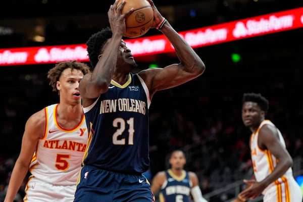 New Orleans Pelicans center Yves Missi (21) heads to the basket against Atlanta Hawks guard Dyson Daniels (5) during the first half of an NBA basketball game, Monday, Dec. 2, 2024, in Atlanta. (AP Photo/Mike Stewart)