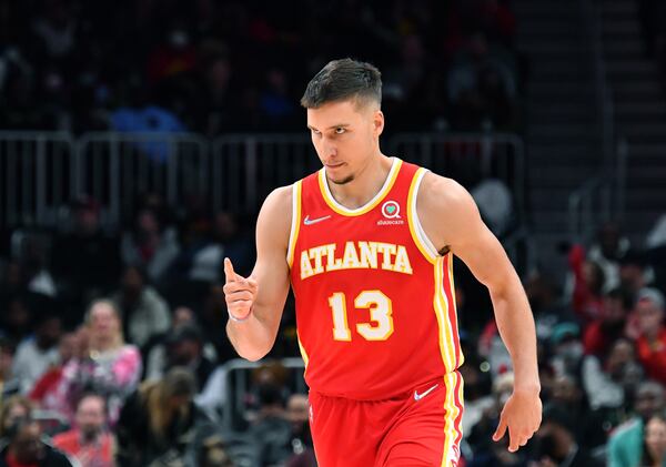 Hawks guard Bogdan Bogdanovic (13) celebrates after scoring during the second half in an NBA basketball game at State Farm Arena on Friday, March 18, 2022. Atlanta Hawks won 120-105 over Memphis Grizzlies. (Hyosub Shin / Hyosub.Shin@ajc.com)