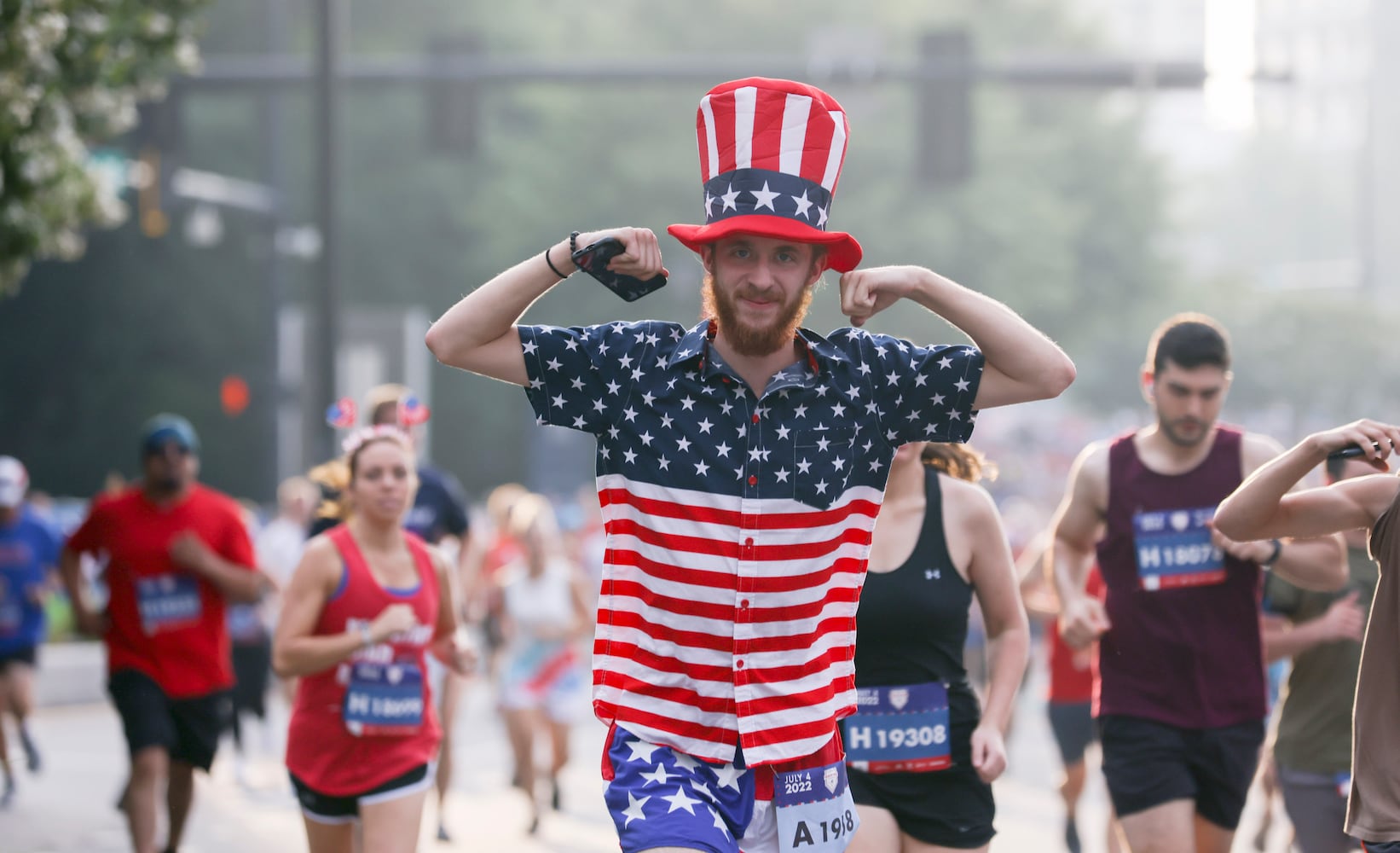 Runners take off at the start of the 53rd running of the Atlanta Journal-Constitution Peachtree Road Race in Atlanta on Monday, July 4, 2022. (Jason Getz / Jason.Getz@ajc.com)