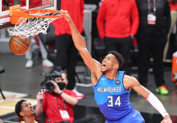 Milwaukee Bucks forward Giannis Antetokounmpo slams over Atlanta Hawks guard Lou Williams during the second quarter of Game 3 of the Eastern Conference finals Sunday, June 27, 2021, in Atlanta. (Curtis Compton / Curtis.Compton@ajc.com)