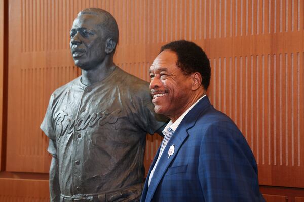 Hall of Fame outfielder Dave Winfield gets his photograph taken next to the Hank Aaron statue by the grand staircase at the National Baseball Hall of Fame, Thursday, May 23, 2024, in Cooperstown, NY. (Jason Getz / AJC)
