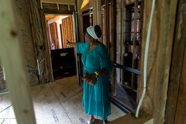 Dorothy Williams, who fell victim to a home repair scam, gives a tour of her gutted home in Atlanta on Monday, May 13, 2024. (Arvin Temkar / AJC)