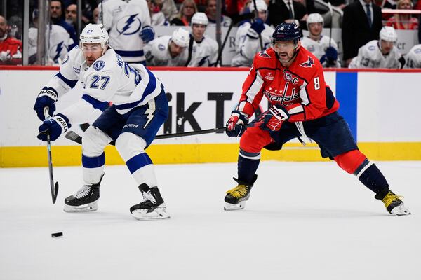 Tampa Bay Lightning defenseman Ryan McDonagh (27) and Washington Capitals left wing Alex Ovechkin (8) skate after the puck during the first period of an NHL hockey game, Saturday, March 1, 2025, in Washington. (AP Photo/Nick Wass)