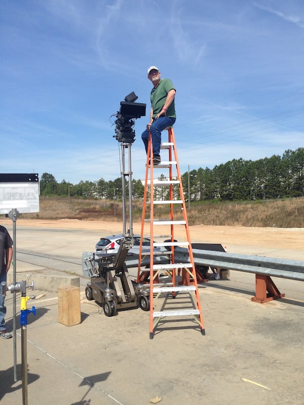 Clyde E. Bryan prepping for a shot high atop a ladder while filming “The Hunger Games” at OFS Studios in
Norcross. Bryan retired after spending nearly 45 years in the film industry. He is currently a Georgia Film Academy professor. Photo courtesy of Clyde E. Bryan.