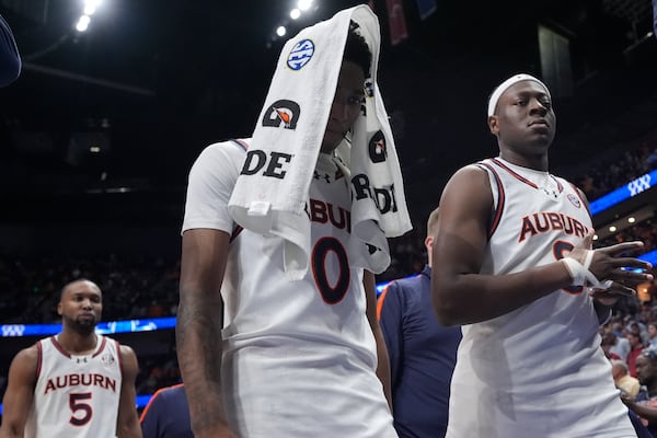 Auburn guard Tahaad Pettiford (0) and teammates leave the court after a loss to Tennessee after an NCAA college basketball game in the semifinal round of the Southeastern Conference tournament, Saturday, March 15, 2025, in Nashville, Tenn. (AP Photo/George Walker IV)