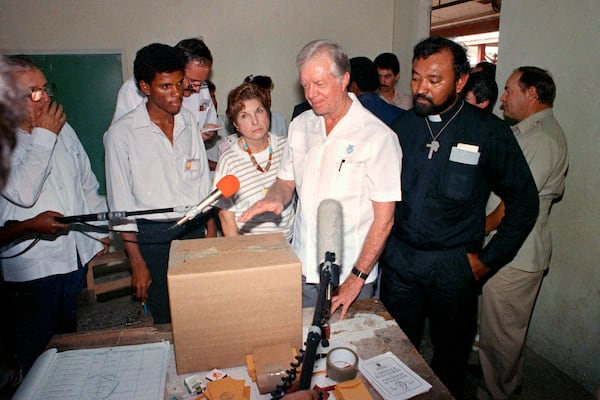 Former U.S. President Jimmy Carter stands in a polling station at San Miguelito, Panama, as part of an international delegation of observers under the Council of Freely-Elected Heads of Government on May 7, 1989. (Luis Romero/AP)