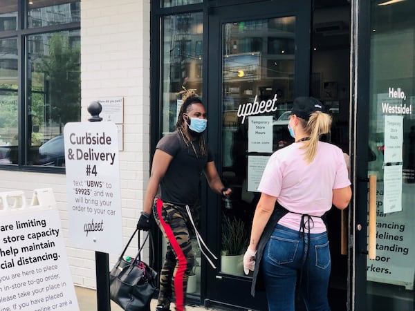 A staffer greets a customer at Upbeet, where masks are required inside. Courtesy of Wendell Brock