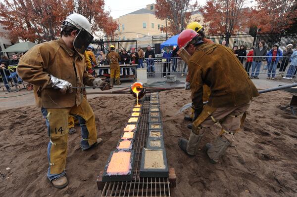 Workers pour iron in scratch molds.