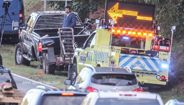 A truck pulled over on Ga. 400 after losing its rear wheel and tire. The tire went over a wall and hit  car, killing the driver, Sandy Springs police said. JOHN SPINK / JSPINK@AJC.COM