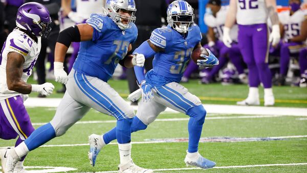 Detroit Lions running back D'Andre Swift (32) rushes-behind blocker offensive guard Jonah Jackson (73) in the second half against the Minnesota Vikings Saturday, Jan. 3, 2021, in Detroit. (Rick Osentoski/AP)