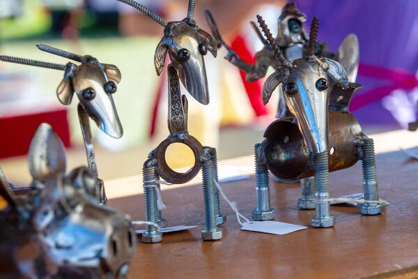 Scrap metal animal sculptures stand on display in Josh and Tiffany Price's tent during the Johns Creek Arts Festival on Sunday, October 17, 2021. (Photo: Steve Schaefer for The Atlanta Journal-Constitution)